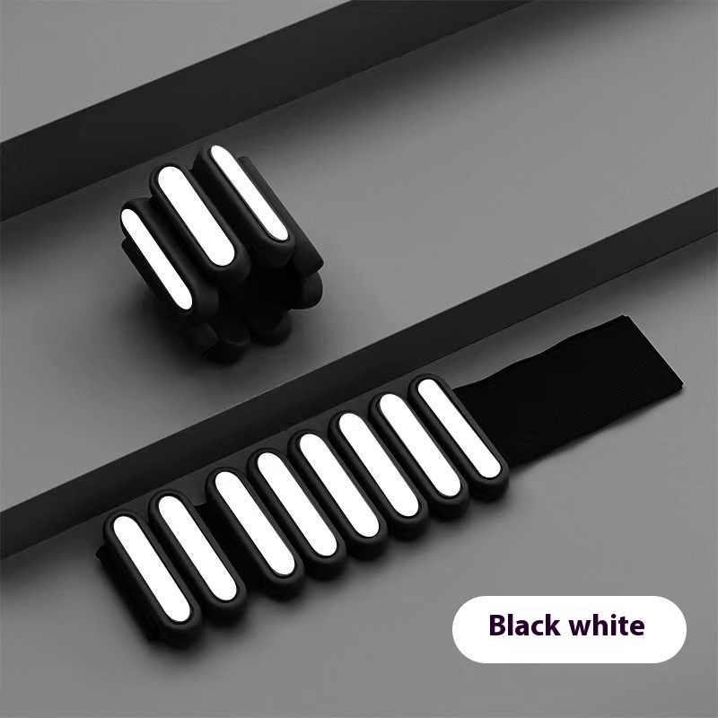 Black and white weight bracelet on a gray surface with 'Black' label