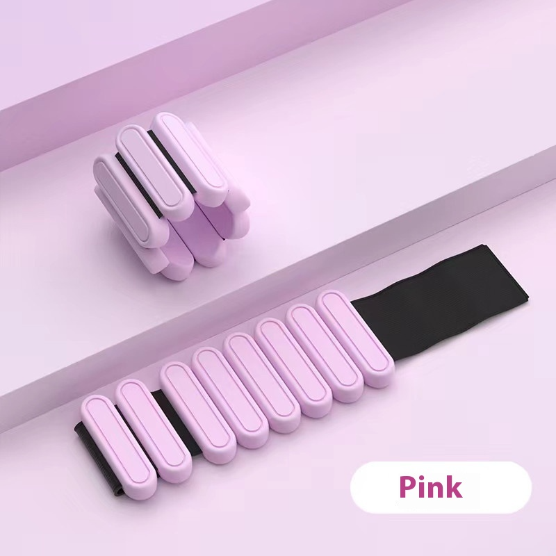 Pink weighted bracelet on a gray surface with 'Pink' label