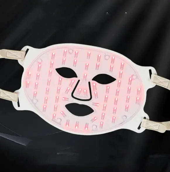 LED face mask with red light pattern on a black background